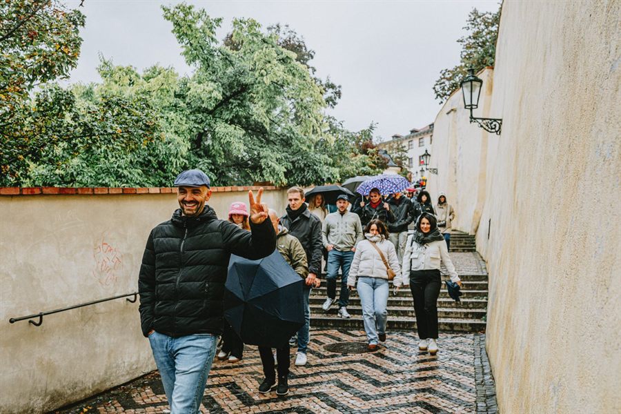 Tour group with umbrellas in an old European street