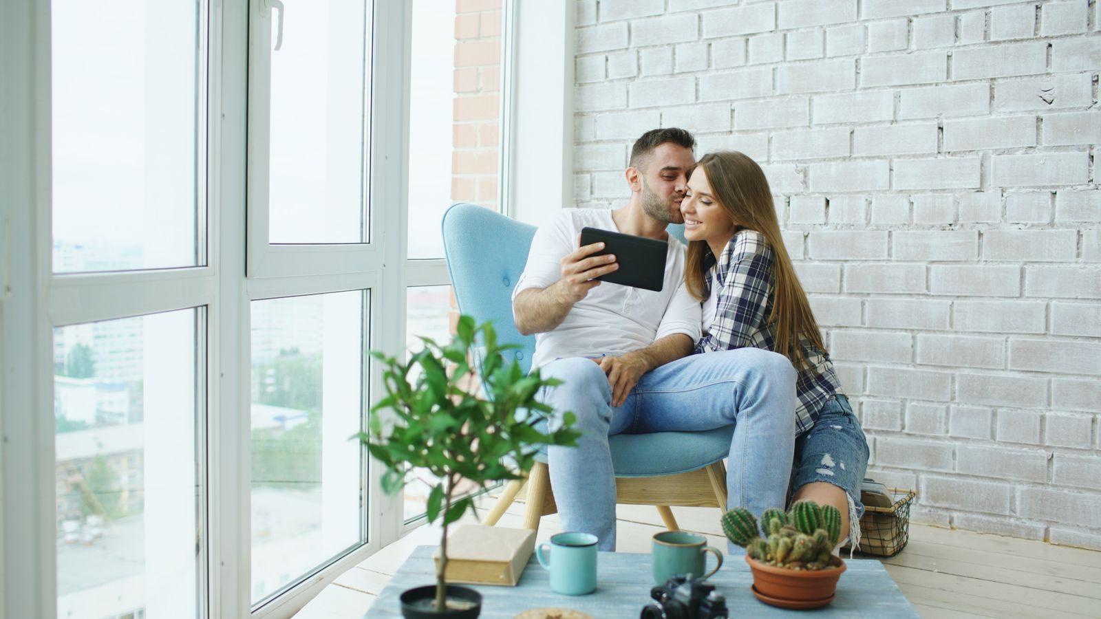 Couple reading river cruise company ratings together on a tablet at home